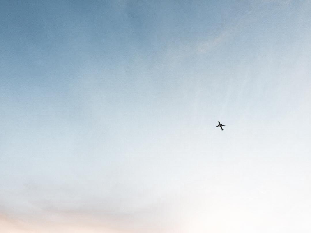 an airplane flying high on the sky